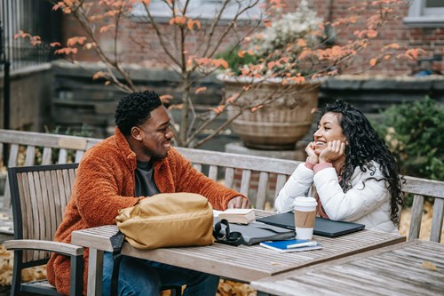 2 people chatting at a table