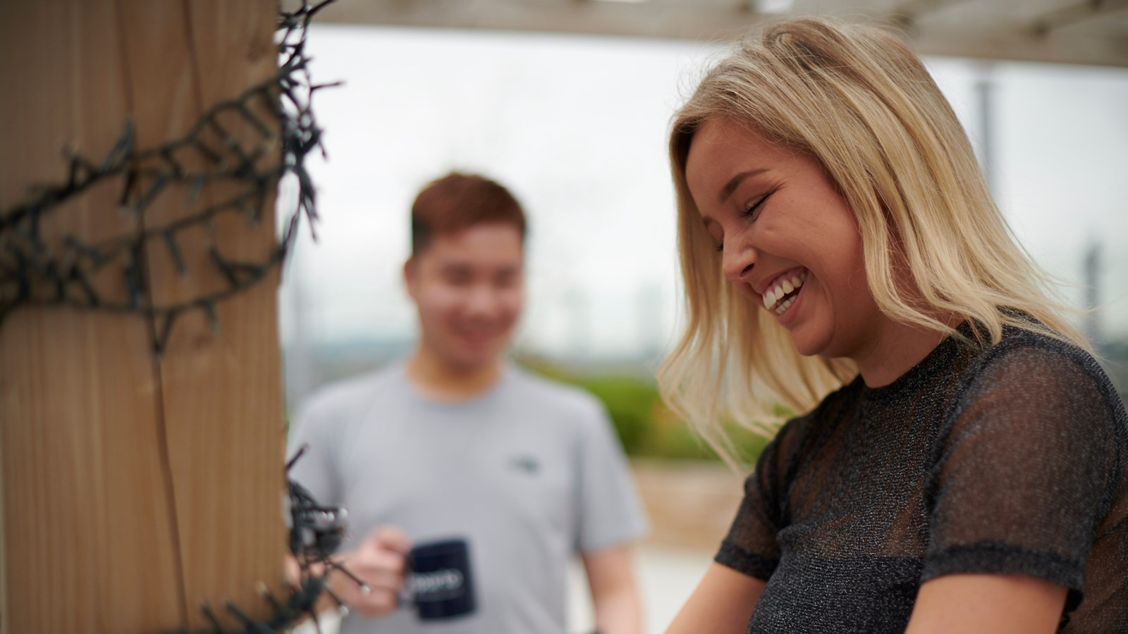 student laughing on the rooftop of aparto beckett house