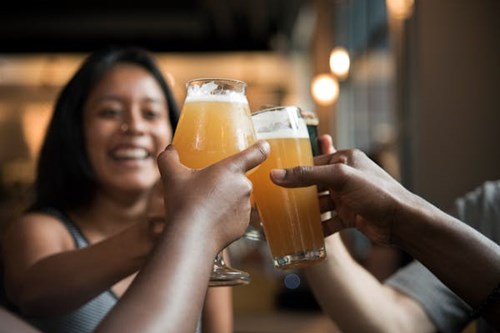 People cheering with beers