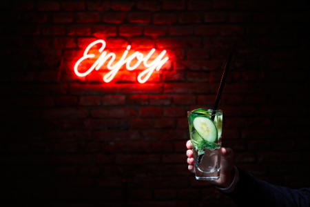 hand holding a drink in a bar