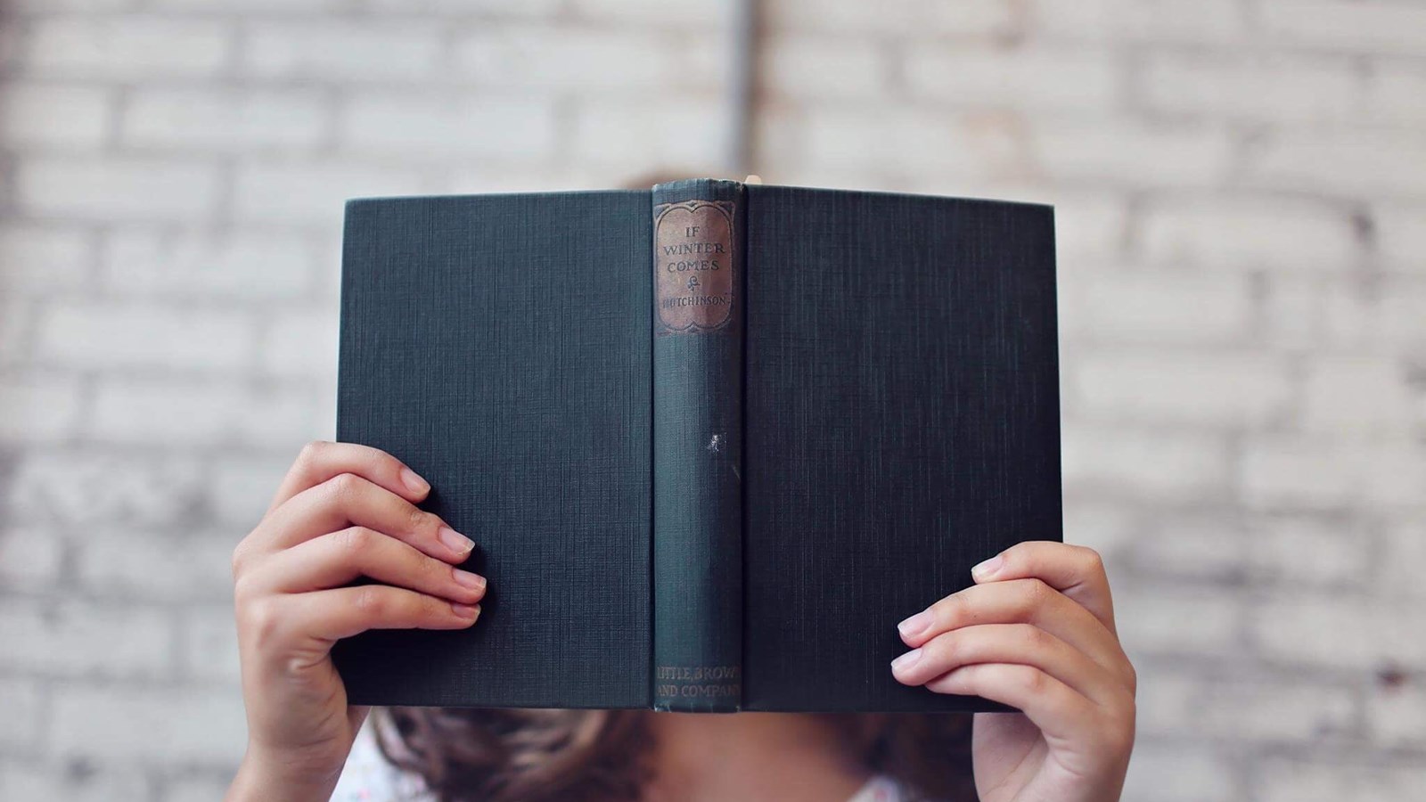 student holding a book