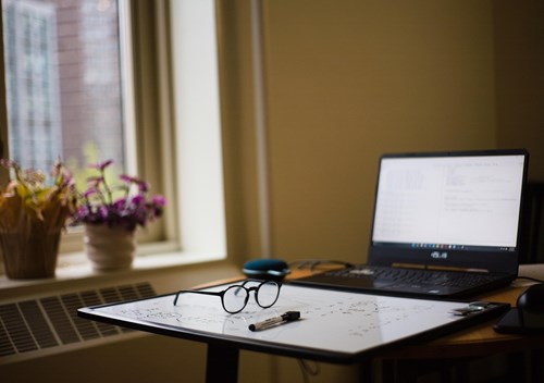 a laptop and a pair of glasses