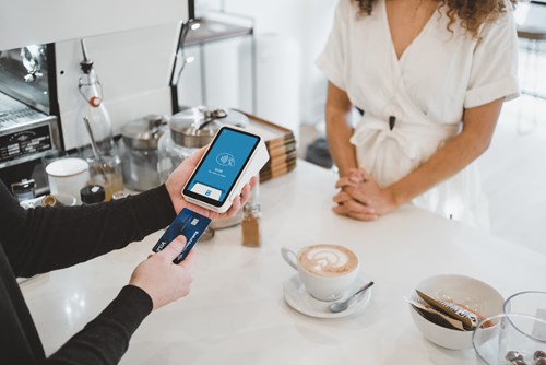 Student making a transaction at a coffee place