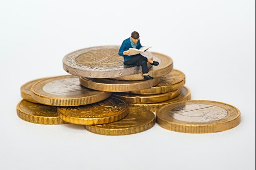 Student sitting on coins