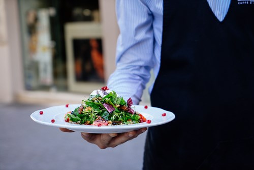 Waiter bringing a salad