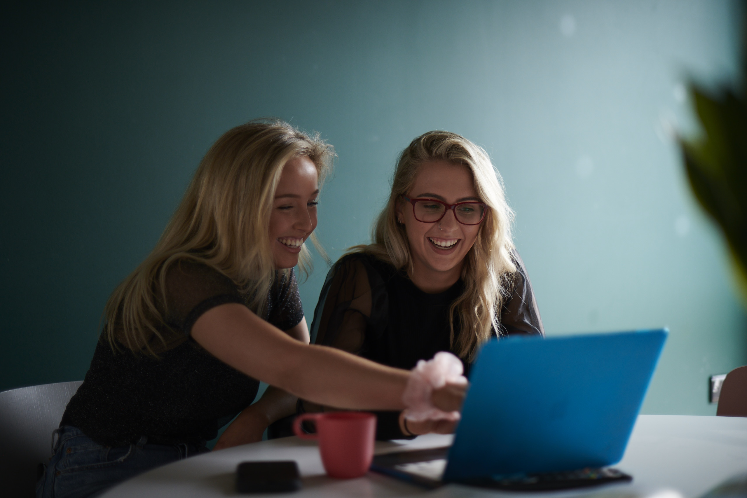 students laughing looking at a computer
