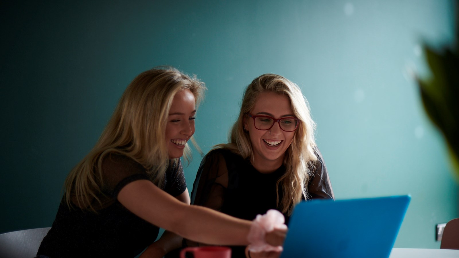 students laughing looking at a computer