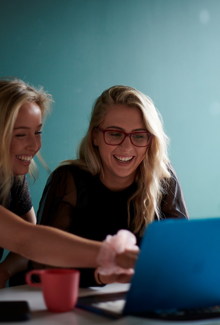 students laughing looking at a computer