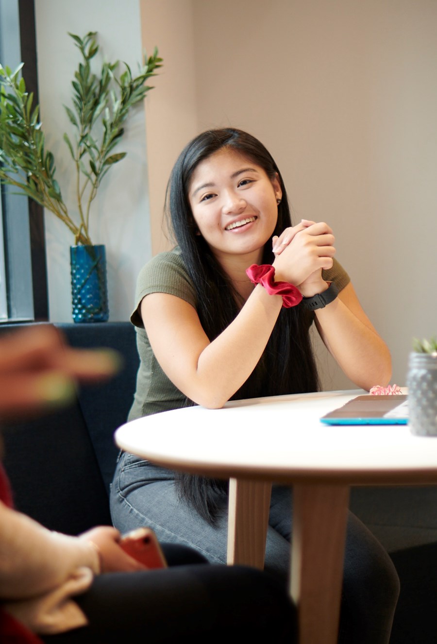 students conversing in beckett house common room