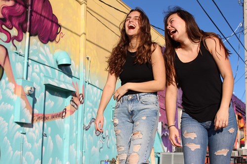 two young women laughing together